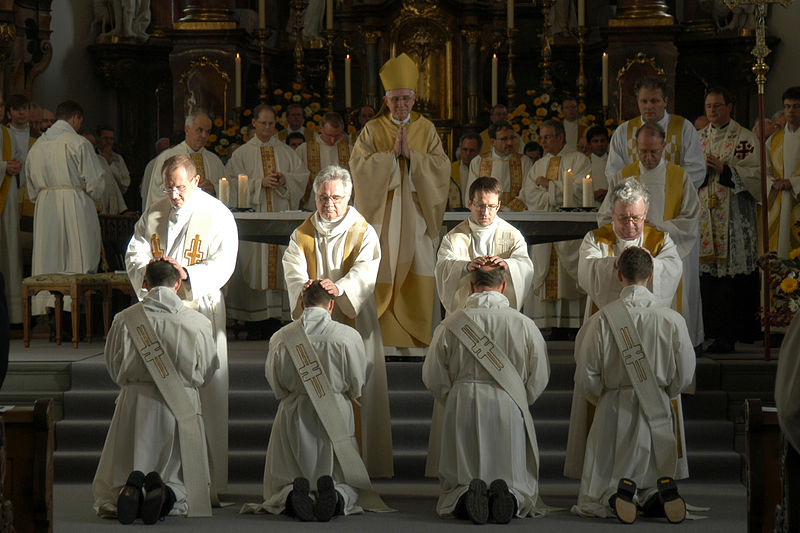 Nowhere does the Bible promote anything like seminaries and the ordination of a clergy. Are Seminaries Biblical?: A photo of four priests laying their hands on four kneeling men receiving the rite of ordination.