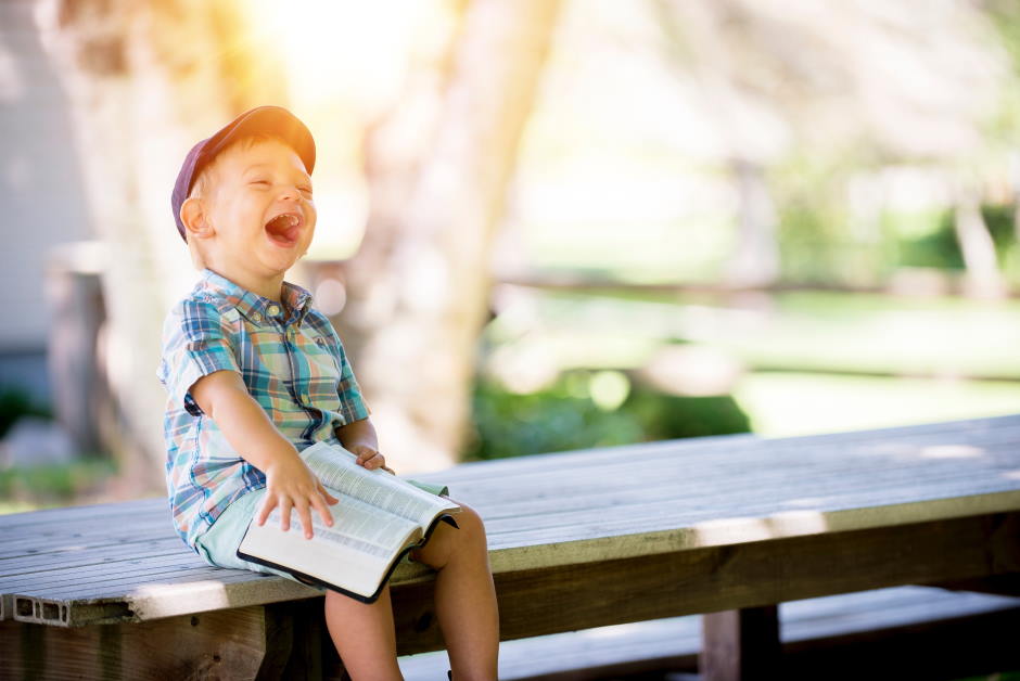The Bible does not, in 2 Corinthians 13:5 or anywhere else, tell us to examine ourselves for evidences of conversion. Instead of examining our own works, we should be focusing on Jesus only. Picture of a boy laughing with an open Bible on his lap. Photo by Ben White on Unsplash.